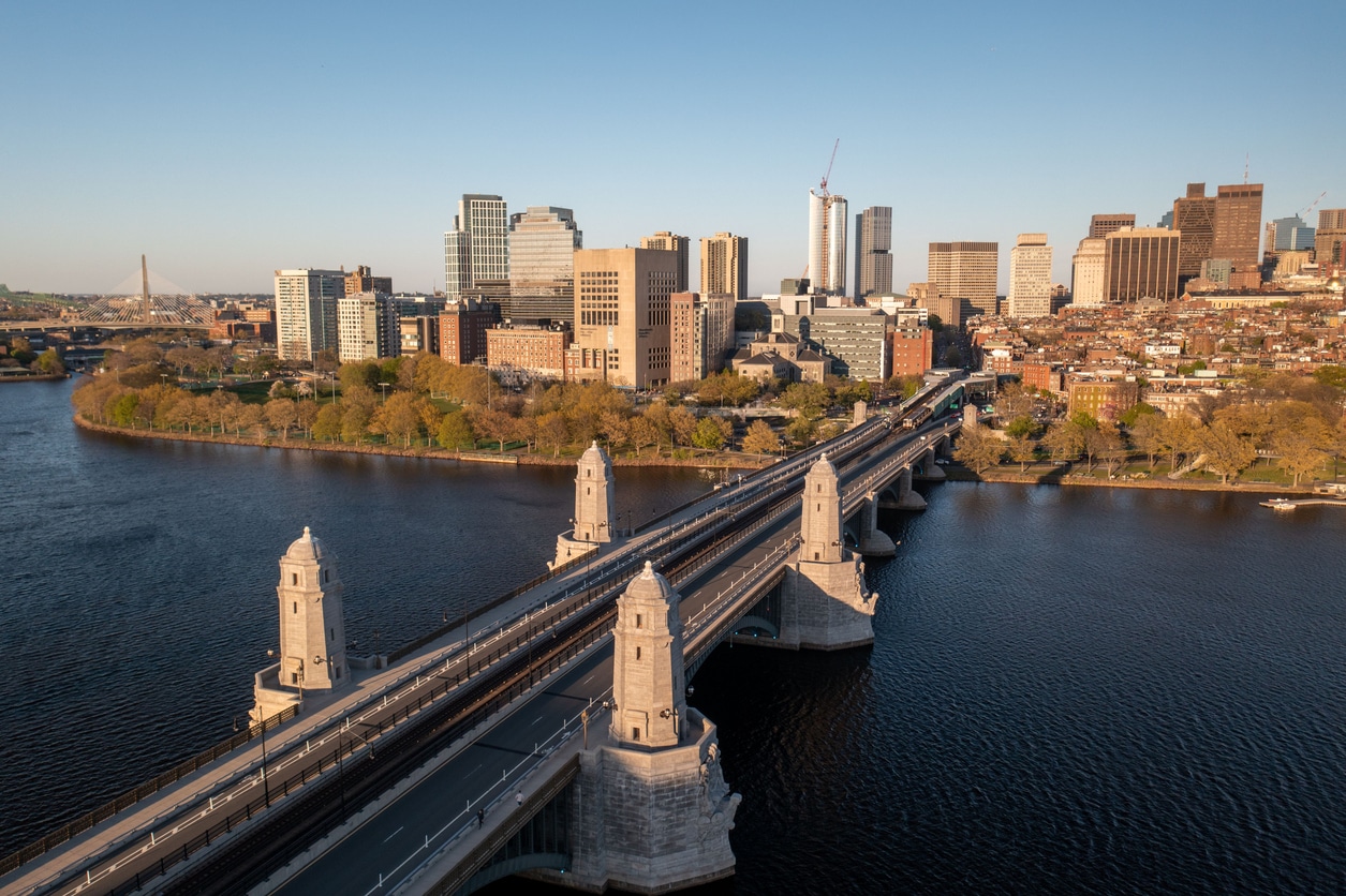 Aerial View of Longfellow Bridge and Boston Skyline Aerial view of a historic stone bridge with four towers crossing a river toward a modern New England city skyline