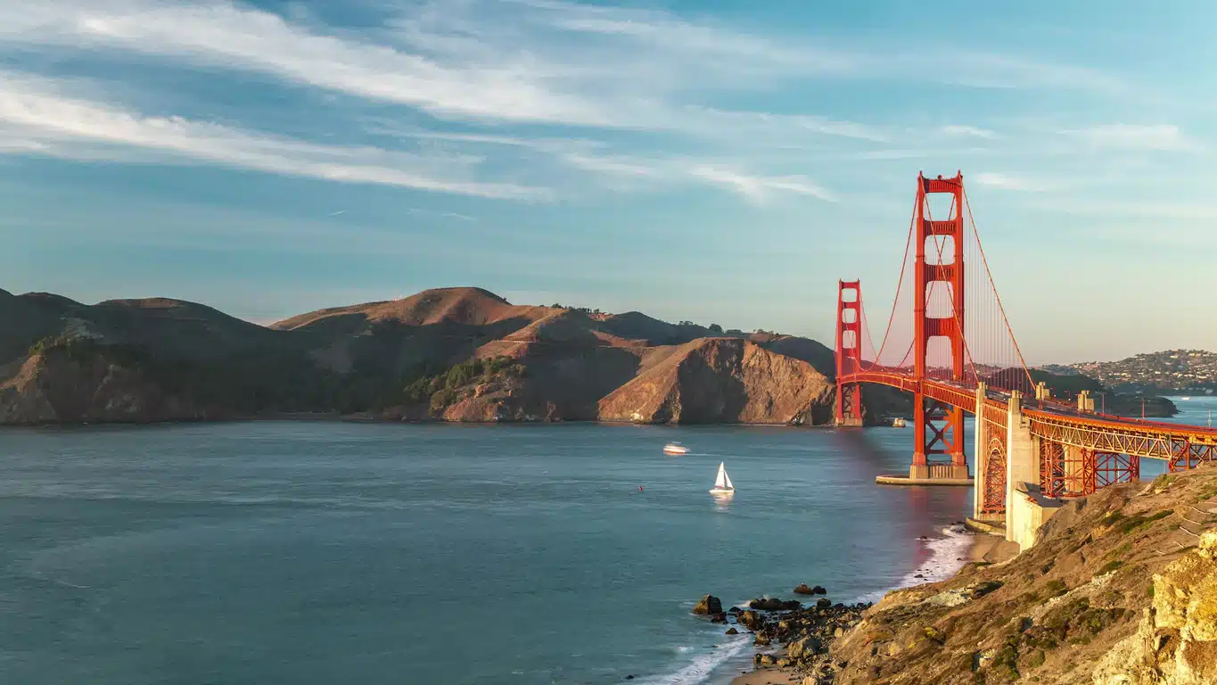 Golden Gate Bridge with hills and ocean under a clear sky, an iconic view for those moving to San Francisco