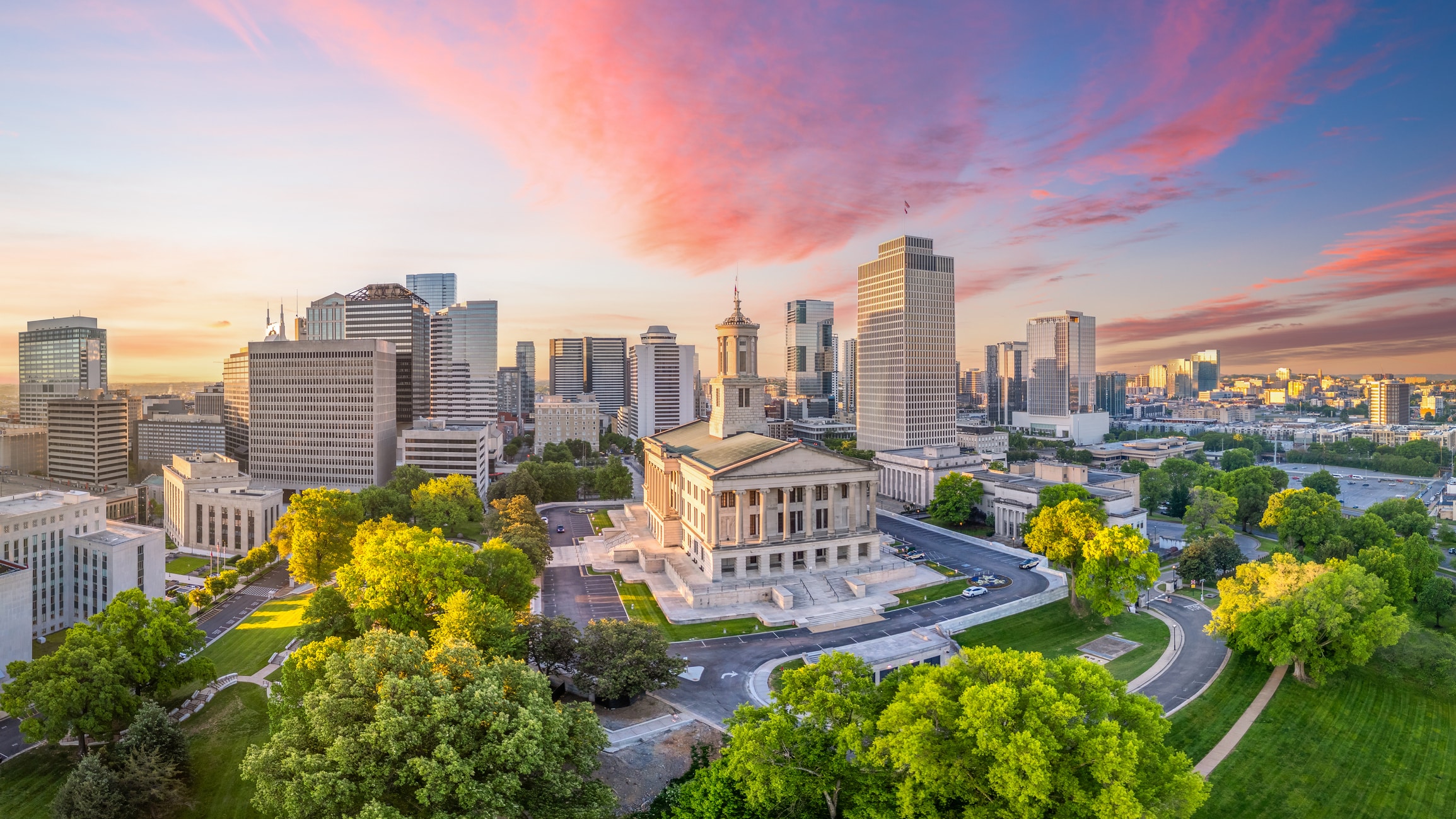 Sunrise view of downtown Nashville, showcasing its vibrant skyline and greenery—a top choice for those moving to Tennessee