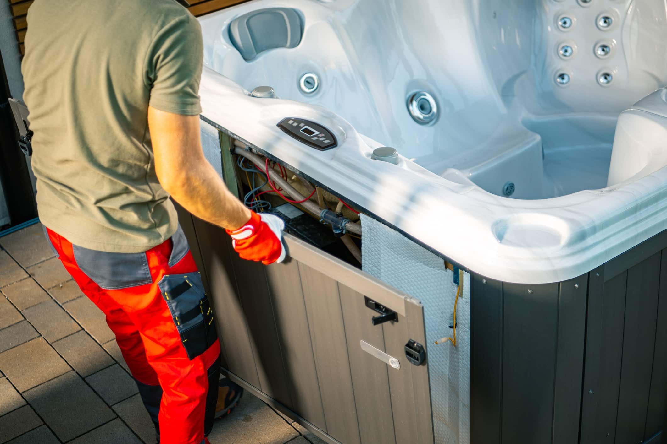 A well-equipped man moving a hot tub