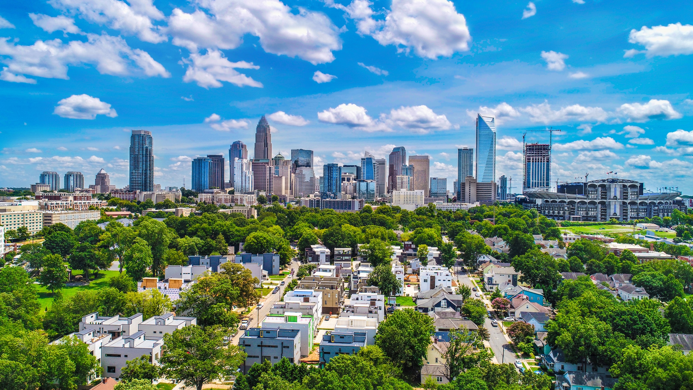 Vibrant, lush neighborhood with Downtown Charlotte in the background