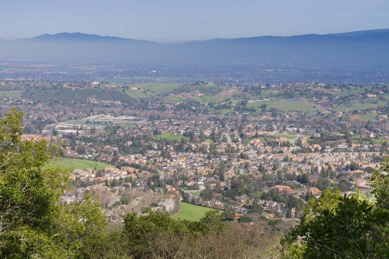 View towards a residential neighborhood in San Jose from the hills of Almaden Quicksilver County Park, south San Francisco bay, California An aerial view of a sprawling suburban valley in San Jose, where many people moving to San Jose choose to settle