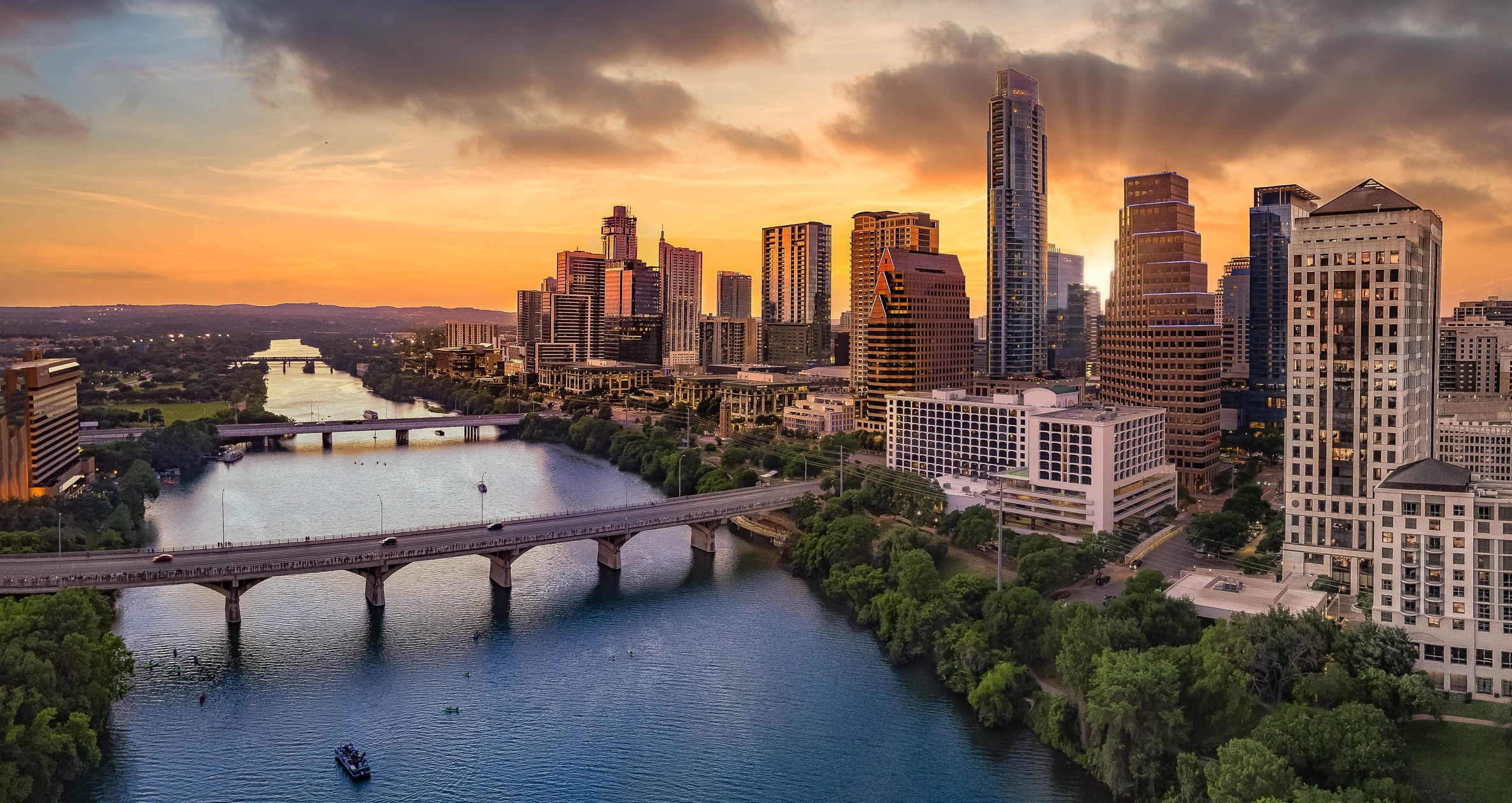 Sunset view of the riverfront in Downtown Austin, Texas, a sight driving people to move to Austin from all over the country