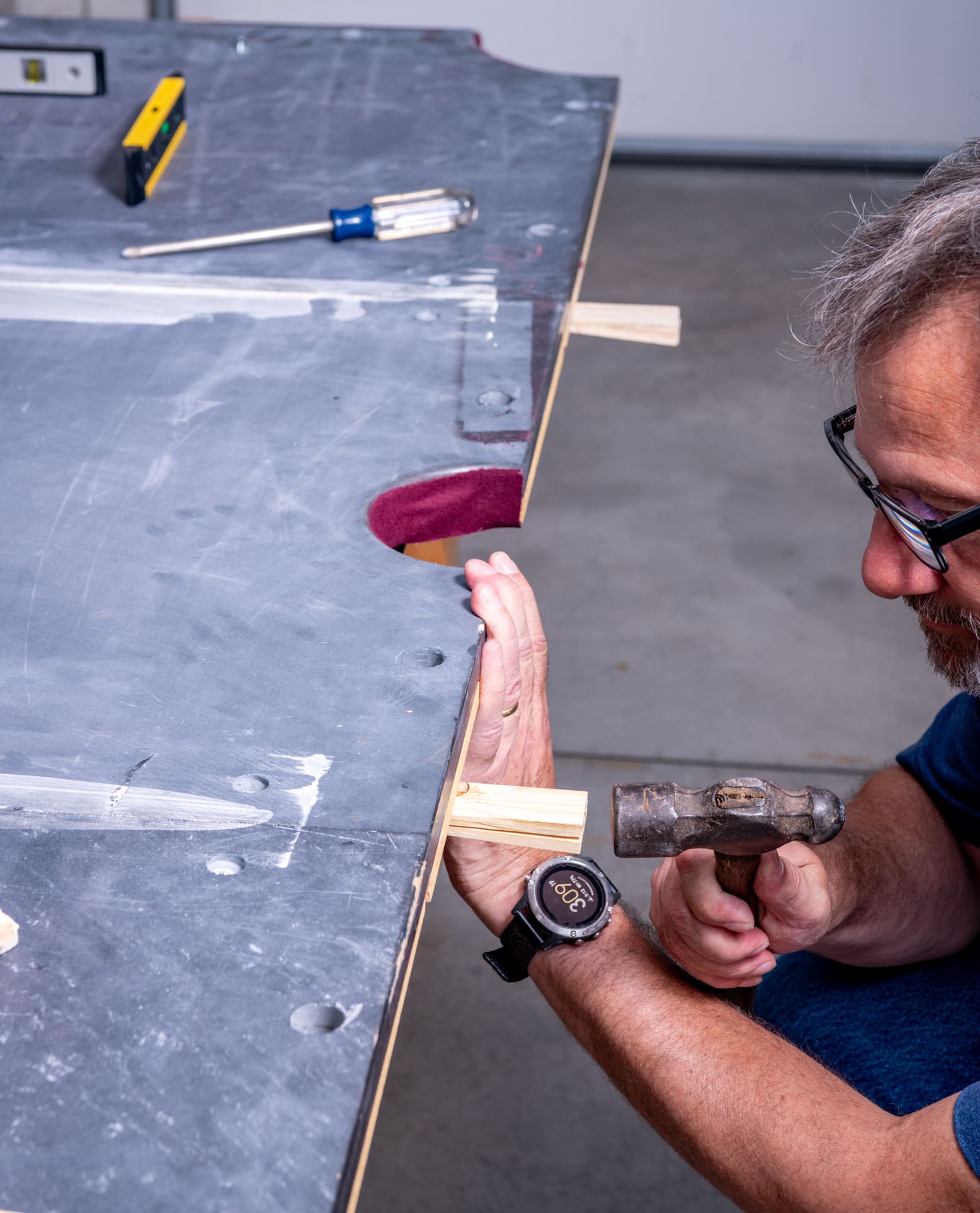 A pool table mover assembling a pool table after a long-distance move