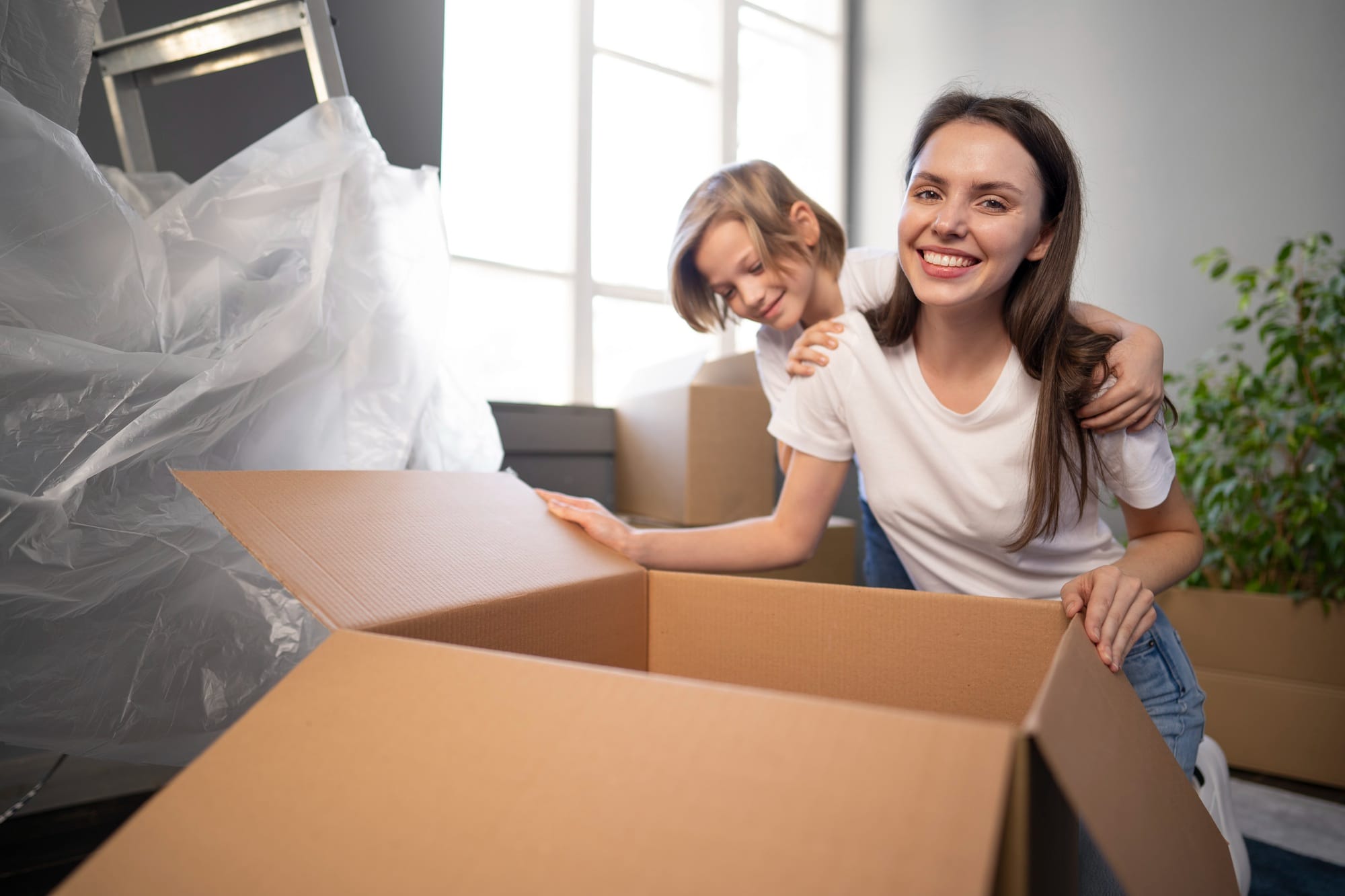 Mom and child packing boxes for moving cross-country