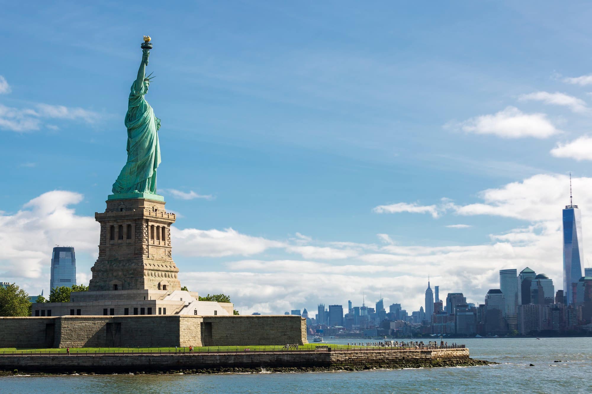 The Statue of Liberty standing tall on Liberty Island welcoming people moving from California to New York City