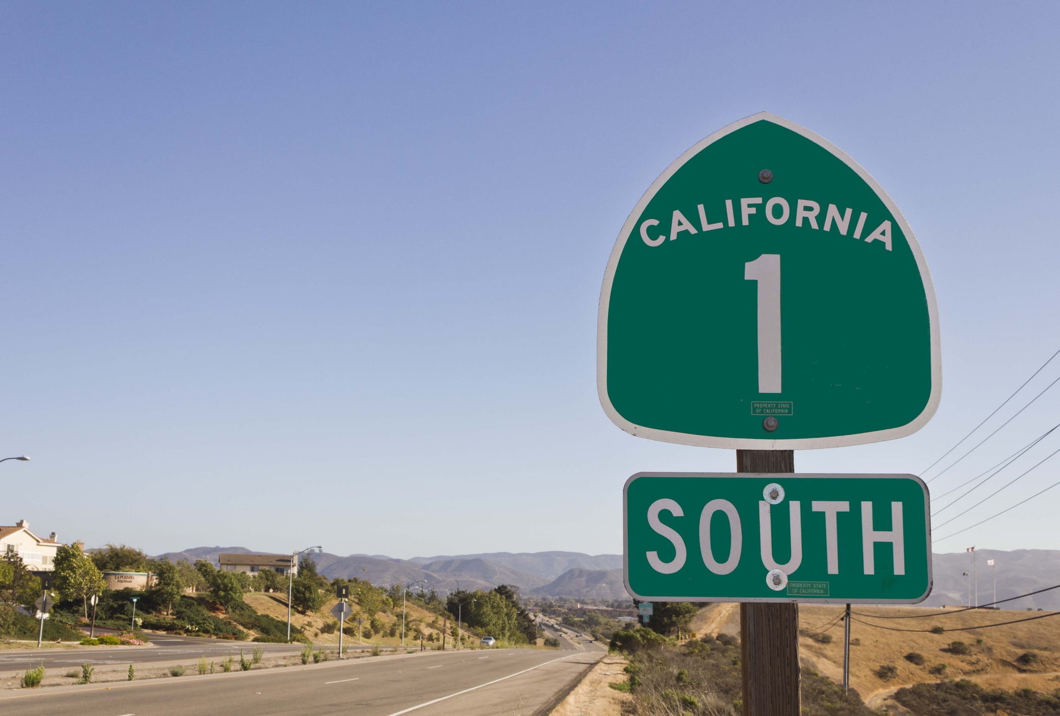 Highway sign reading “California,” greeting those moving from New York to California for new opportunities