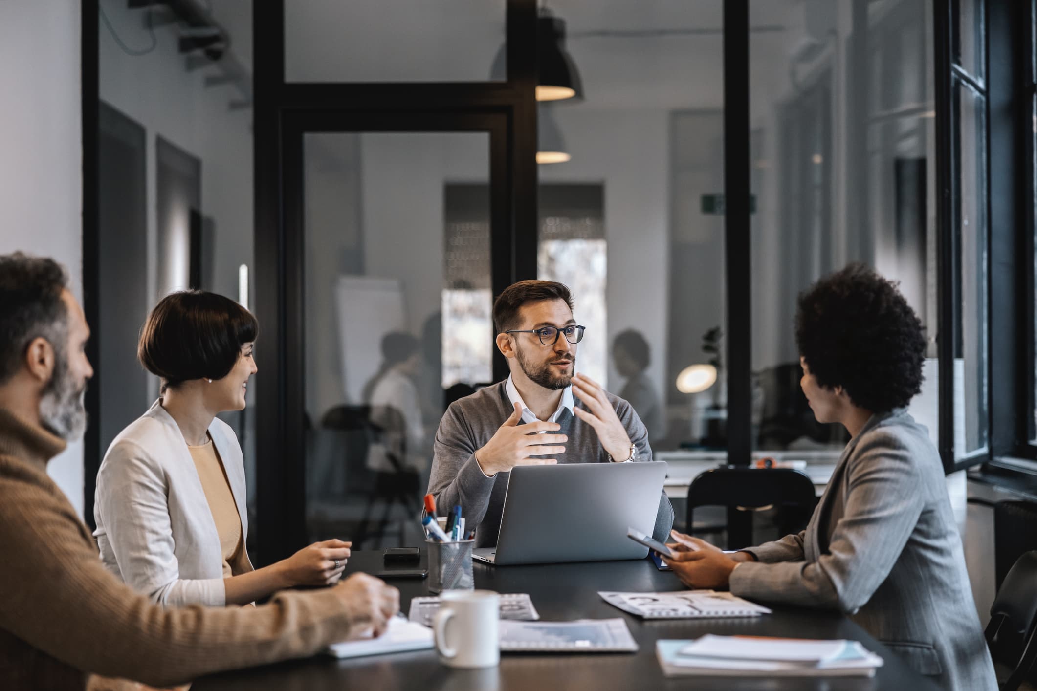 Professionals collaborating in an office in Raleigh, NC, highlighting one of the benefits of living in Raleigh