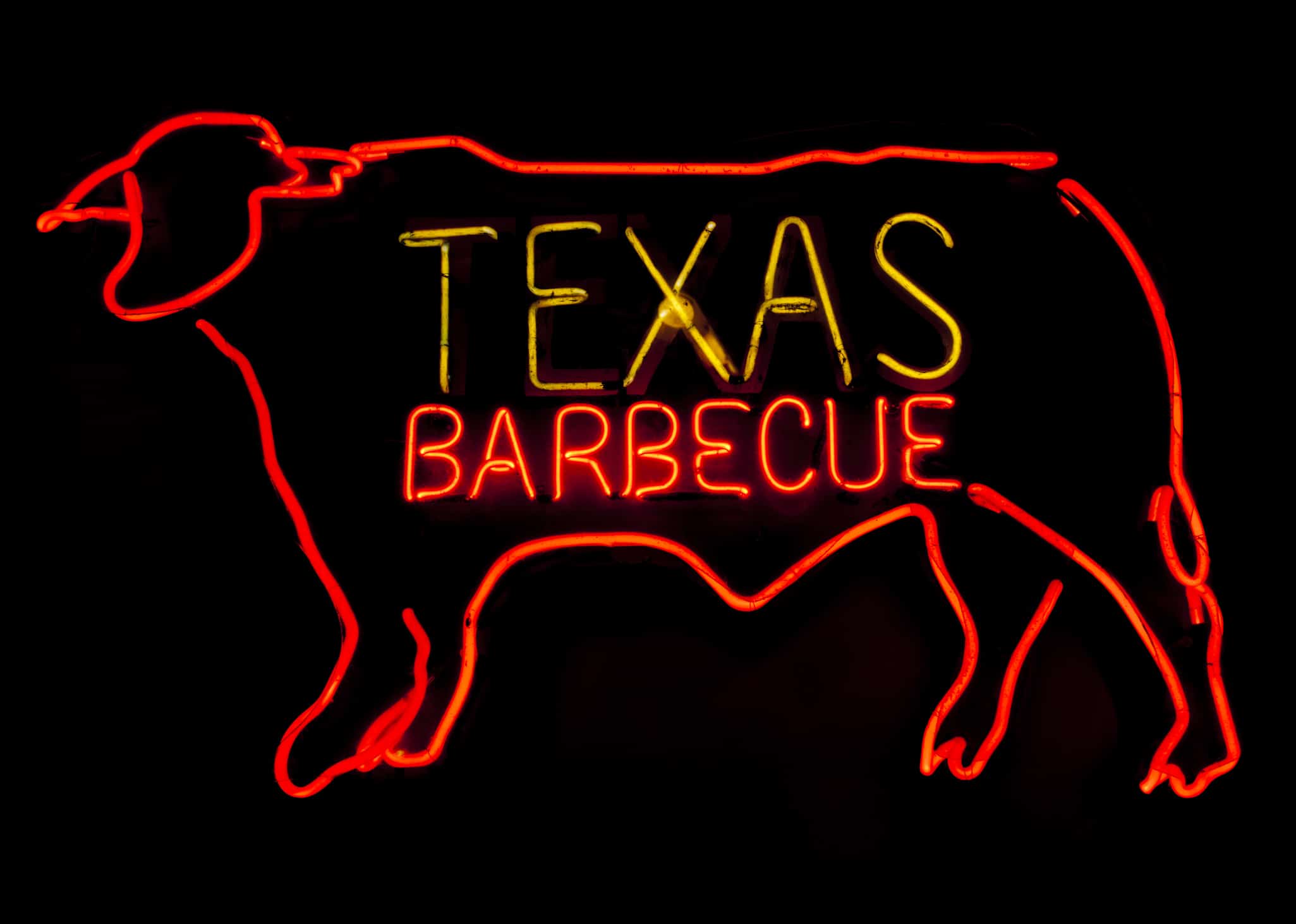 Neon Texas BBQ neon sign, symbolizing Austin's vibrant culture and food scene for those moving to Austin, Texas