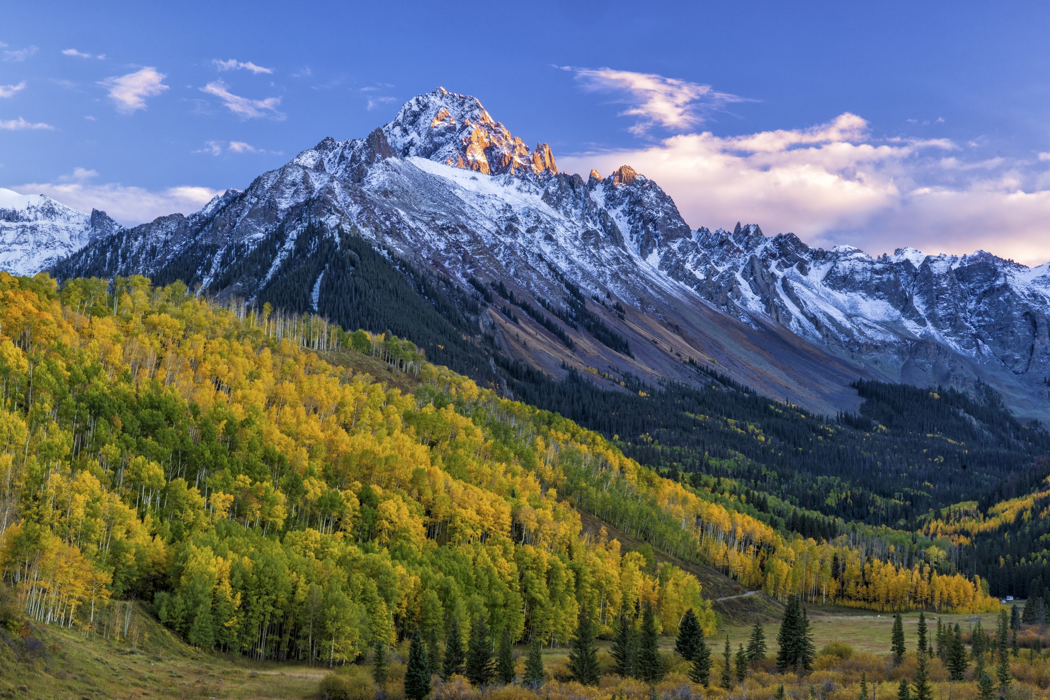 The San Juan Mountains, offering stunning views and cooler temperatures for those moving to Colorado