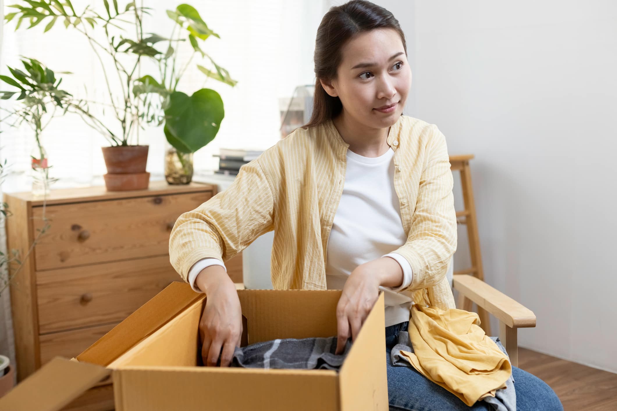 A woman packs her “first night box,” an essential step in packing for a move