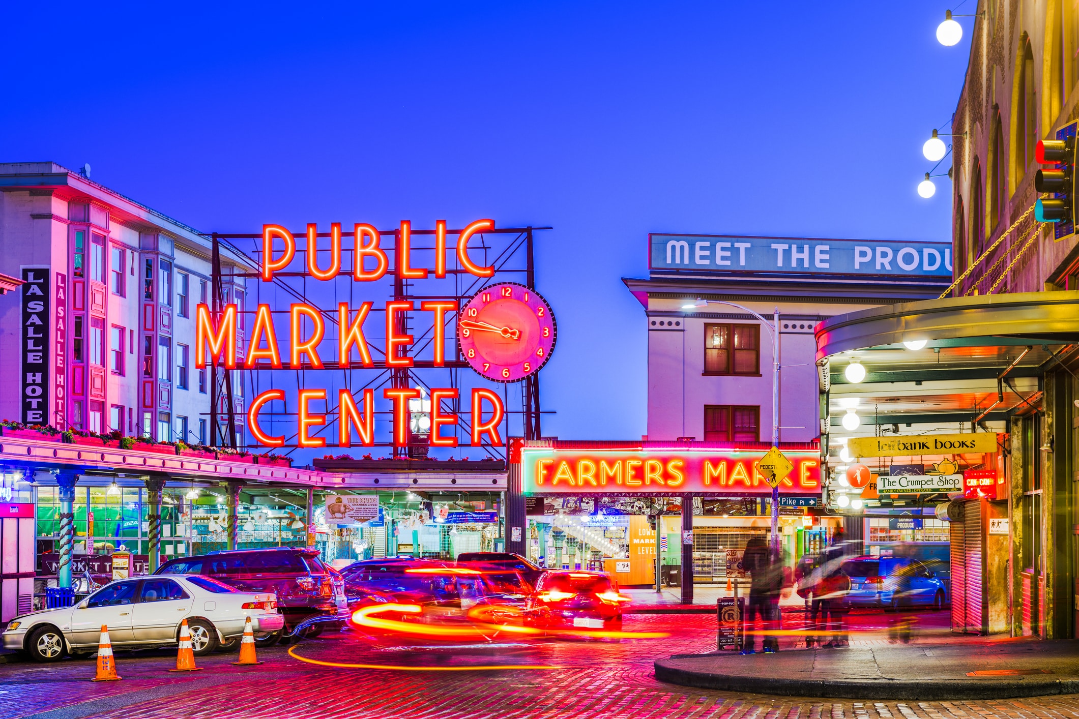 Neon signs at Pike Place Market, showcasing the food and diversity awaiting those moving to Seattle