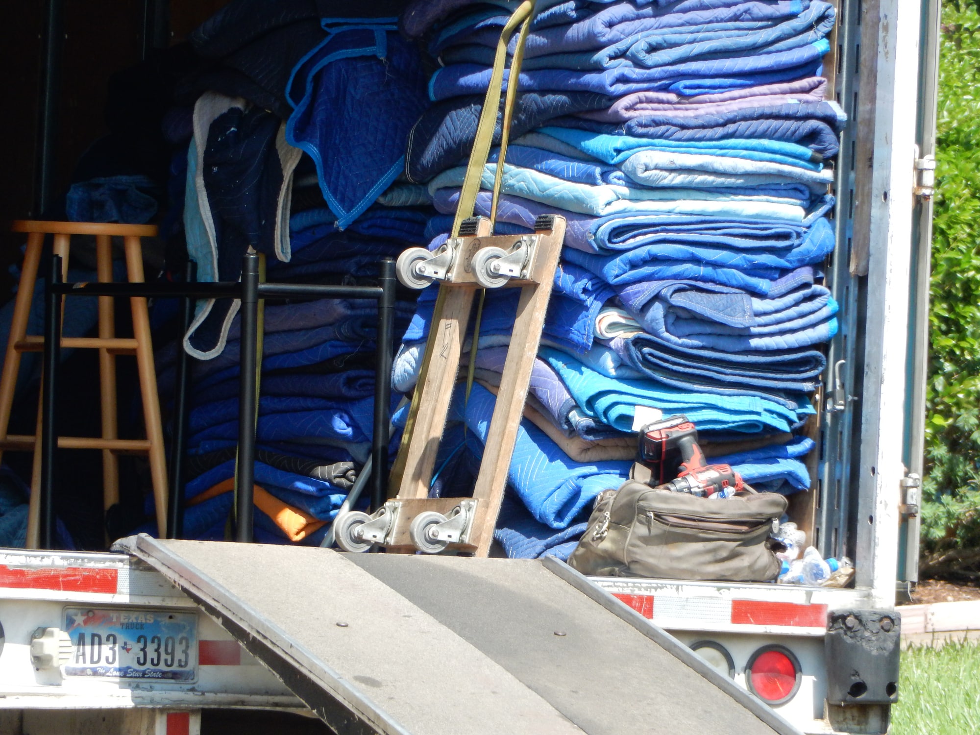 A pile of moving blankets and other supplies that are essential for moving a piano