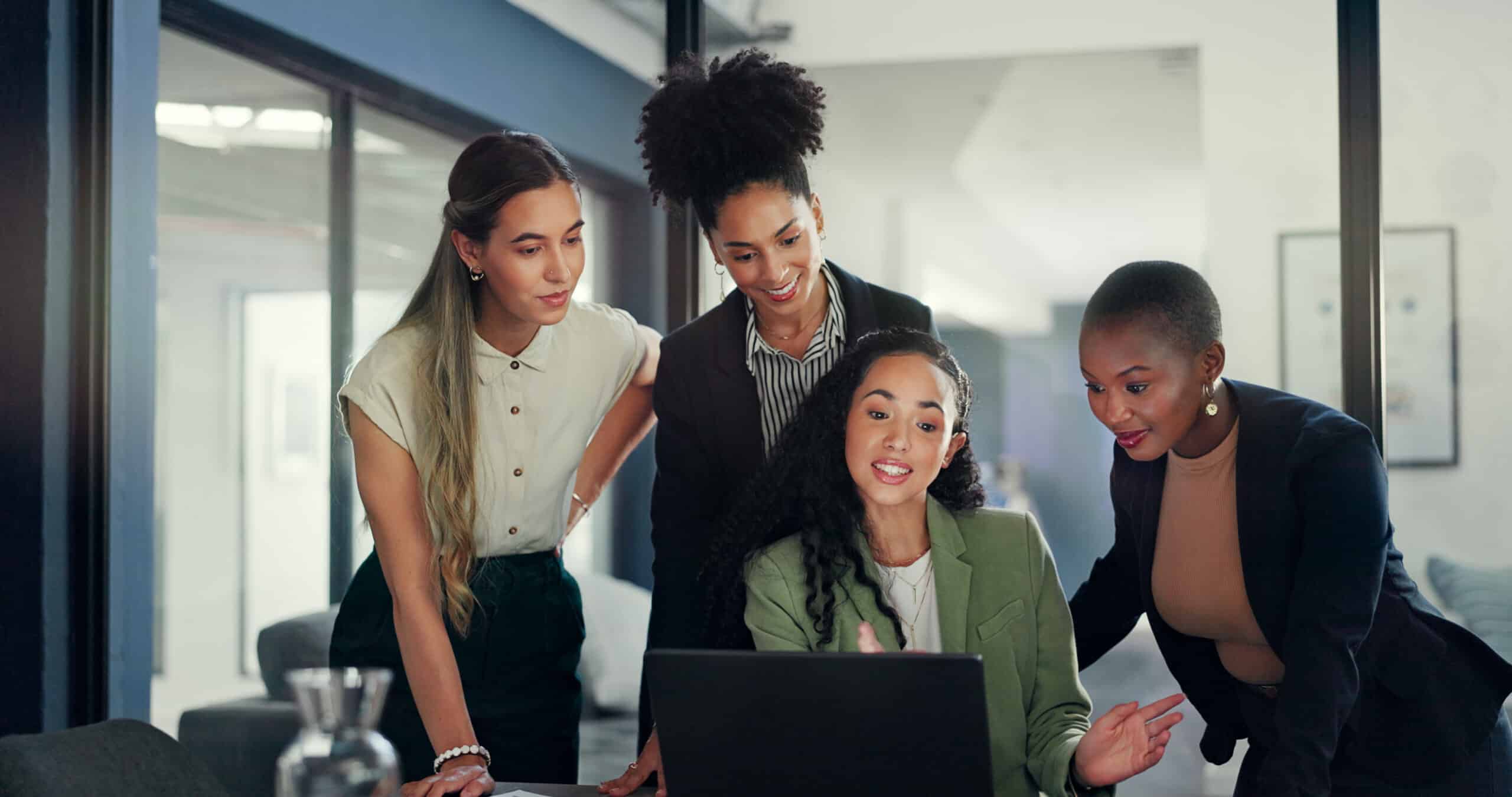 Four women collaborate in a modern office, reflecting Fort Lauderdale's thriving job market