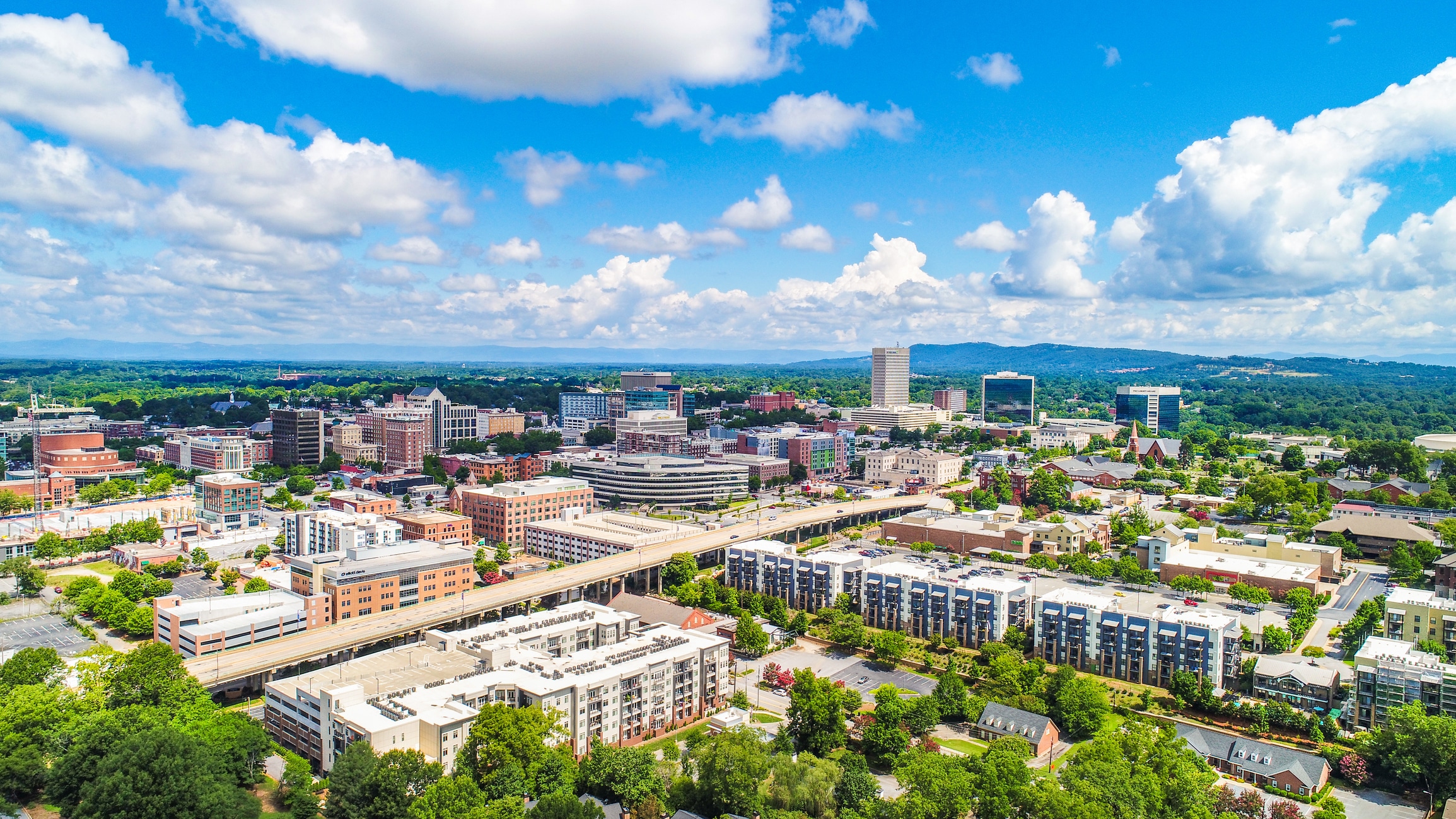 Scenic view of Falls Park on the Reedy in Downtown Greenville, featuring cascading waterfalls and bridges