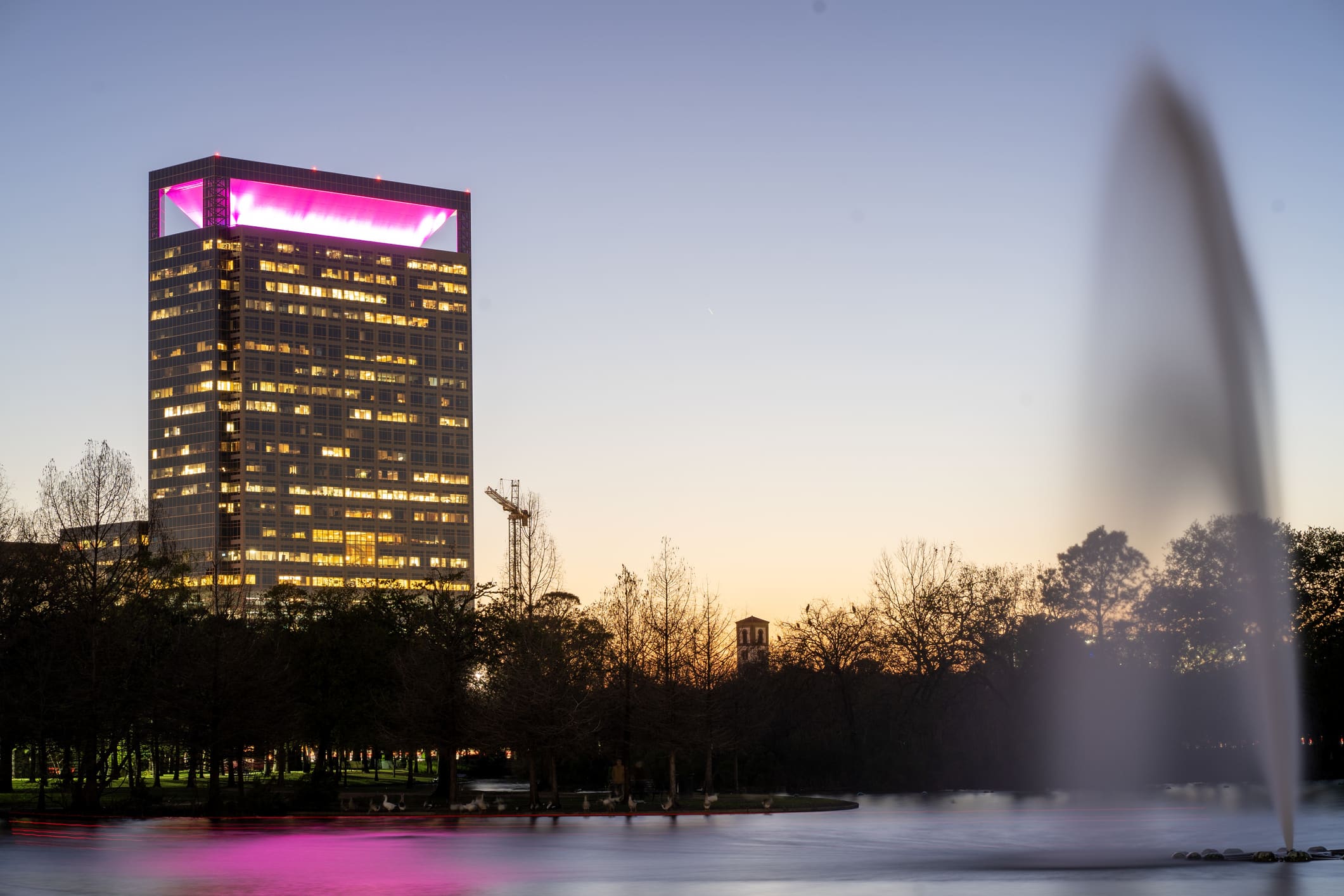 A twilit lake at Hermann Park, located in the museum district of Houston, one of the best neighborhoods in Houston