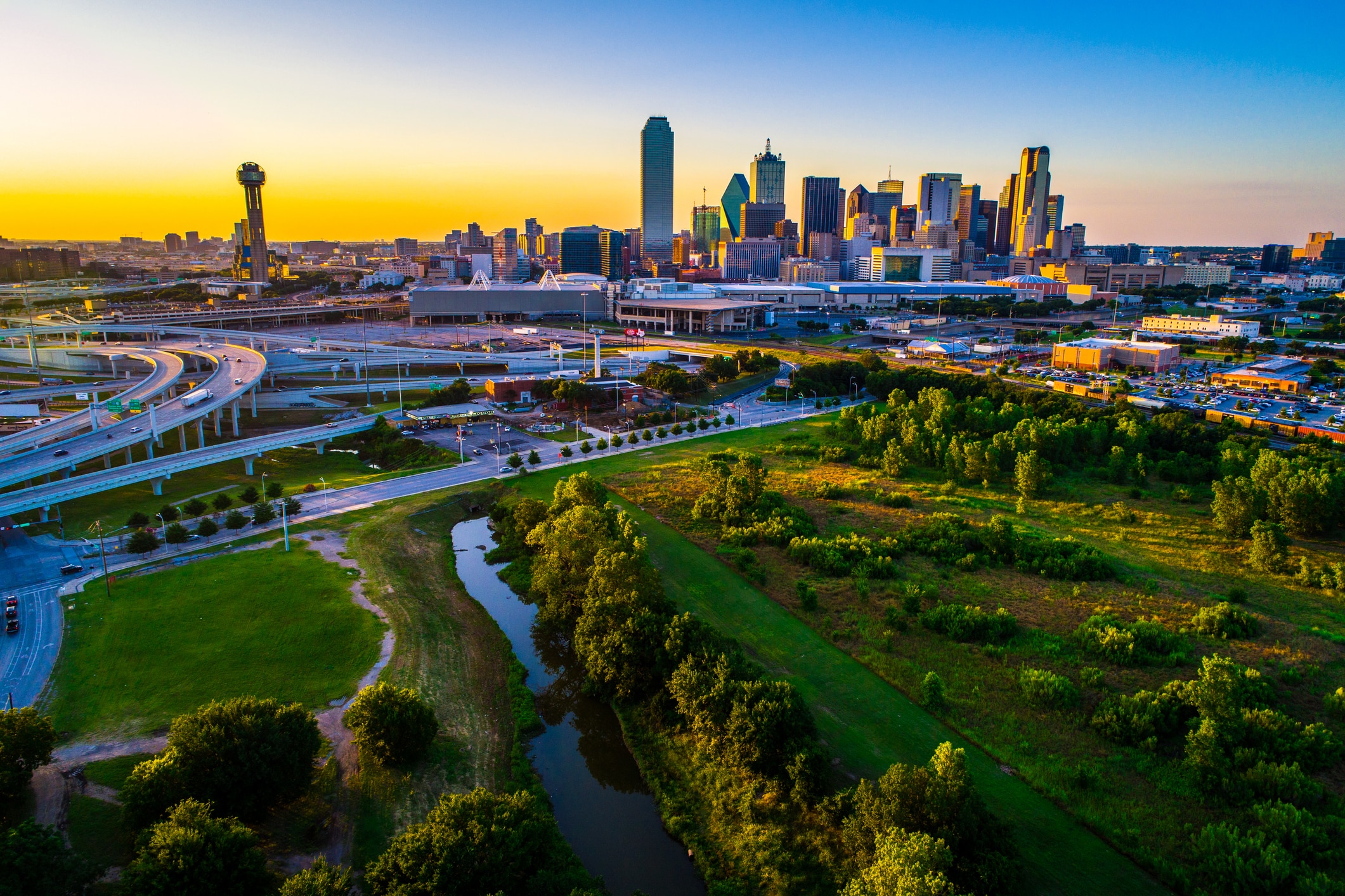 Lush park foreground with downtown Dallas in the background, a beautiful sight awaiting those moving to Dallas