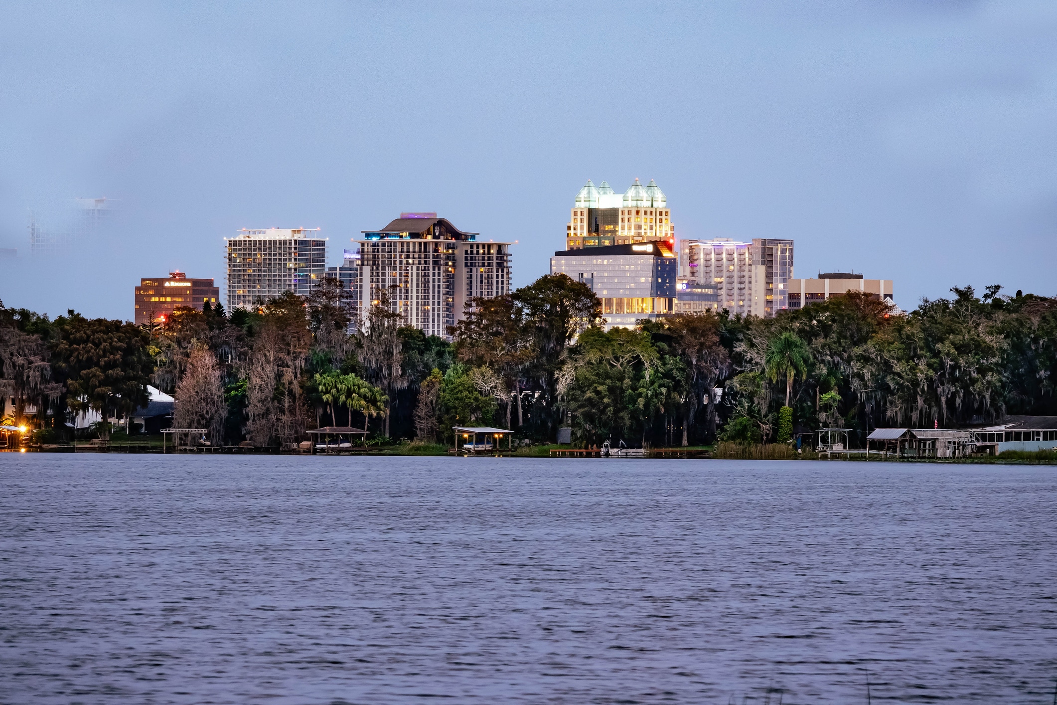 A lake in Orlando, Florida in the evening with beautiful tall buildings lit up in the background