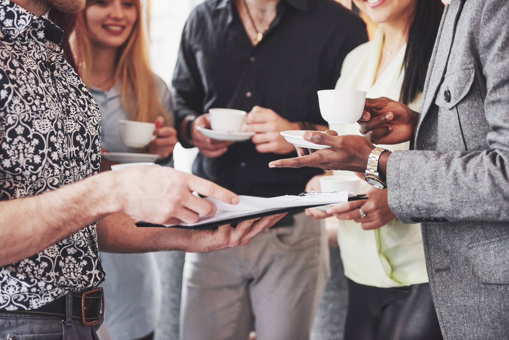 A group of people networking over coffee at a live event