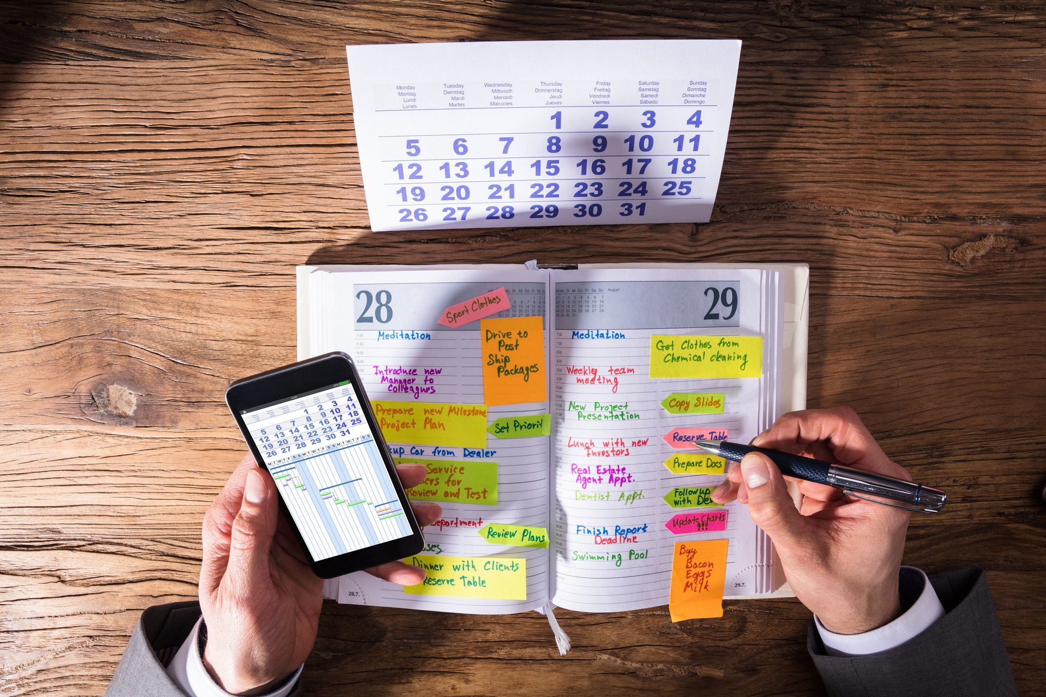 A man filling through his planner and organizing his move