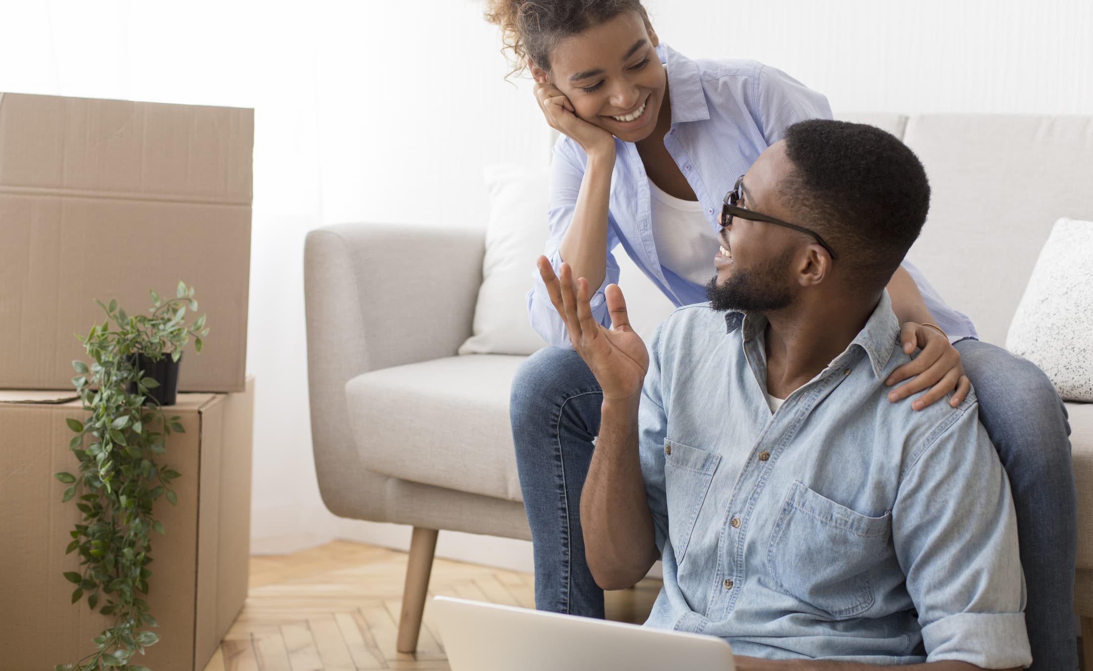 A couple happily and openly talk about relocating for a job as they pack their belongings