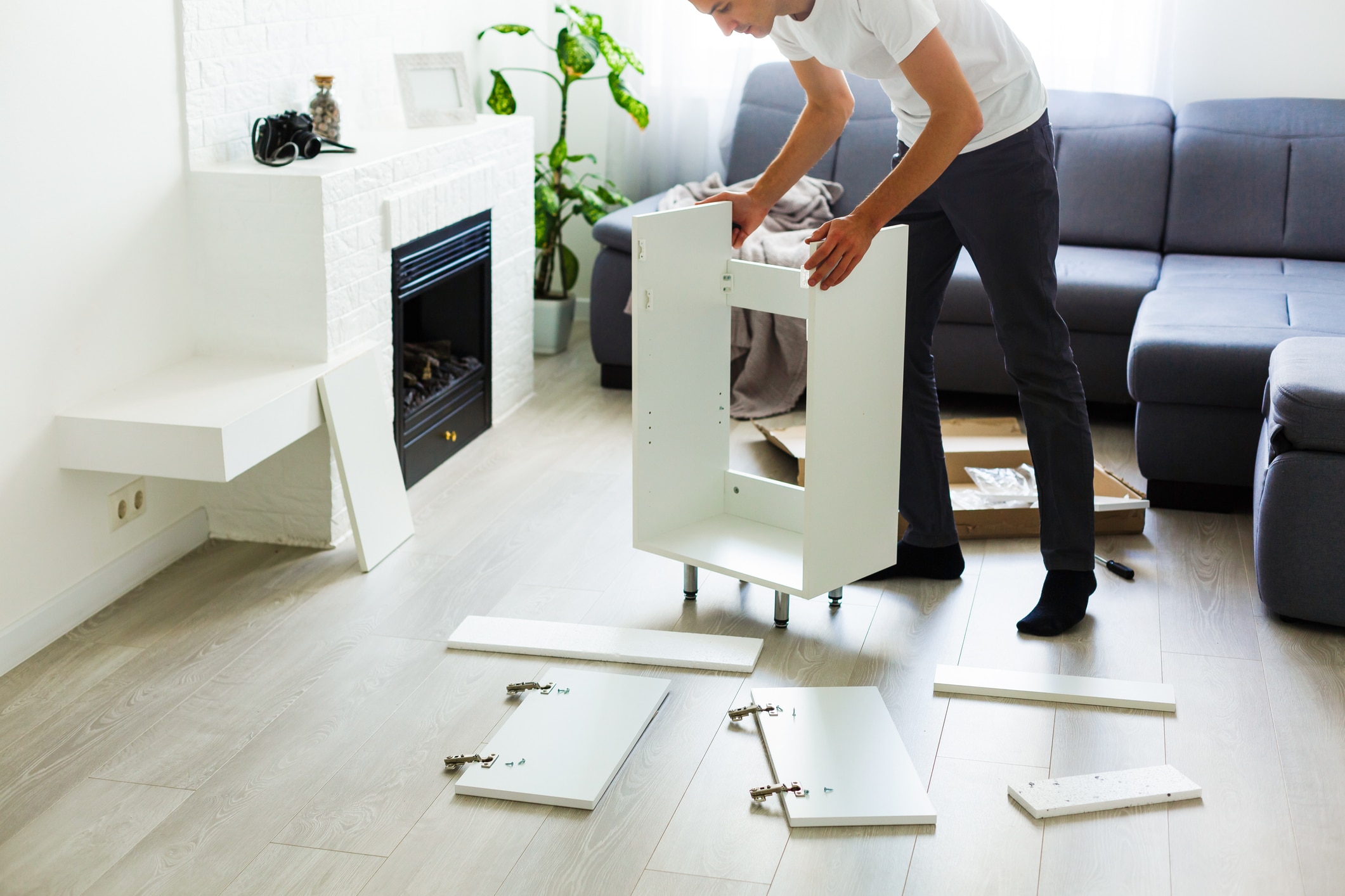 A woman disassembling her furniture prior to moving, a great moving hack