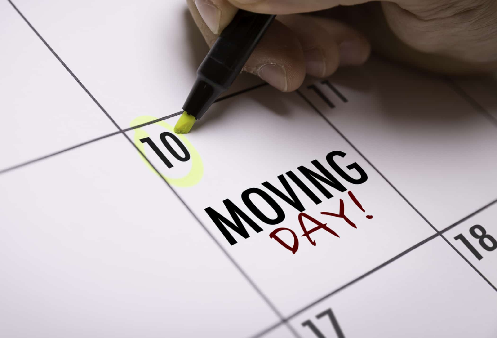 A person marking their moving day on their calendar