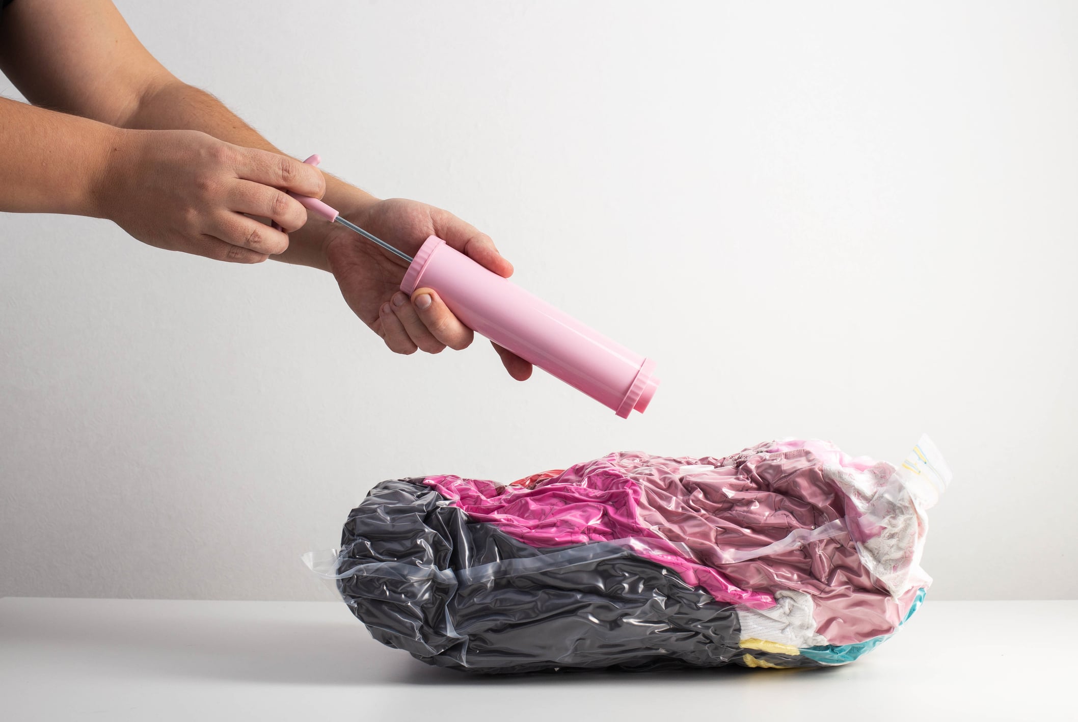 A person successfully vacuum-sealing light yet bulky items as a packing tip for moving