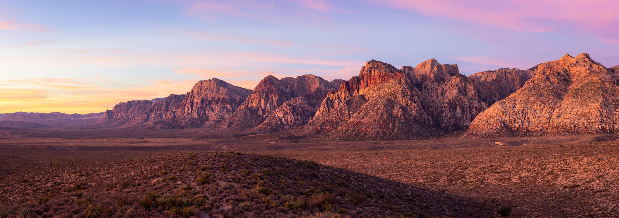 Panoramic shot of Red Rock Canyon at colorful sunrise near Las Vegas, Nevada Sunset panorama of Red Rock Canyon National Conservation Area, a popular attraction for those living in Las Vegas