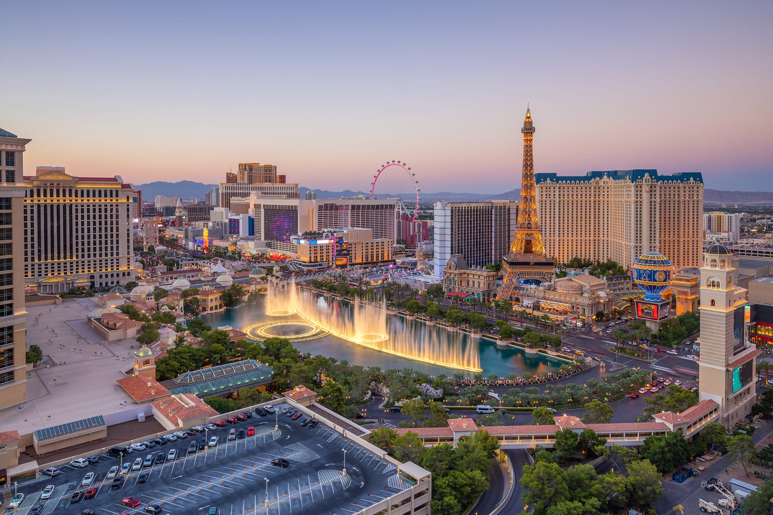 The iconic Las Vegas strip with the Eiffel Tower lit up at dusk