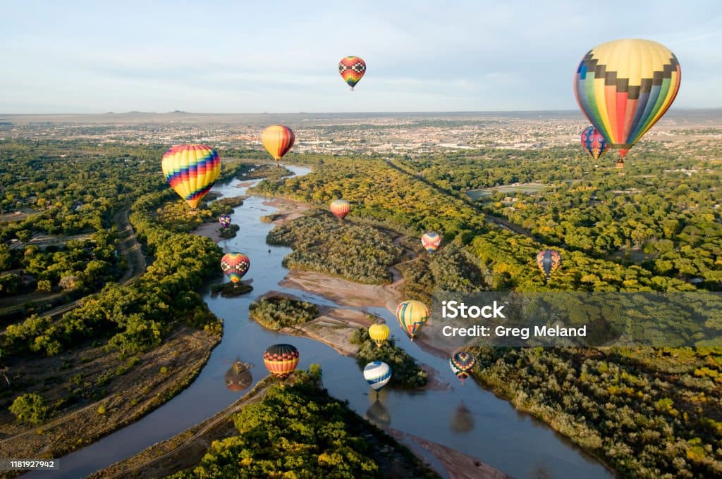 Hot air balloons drifting over the Rio Grande river in Albuquerque, New Mexico. Hot air balloons drifting over the Rio Grande river in Albuquerque, New Mexico.