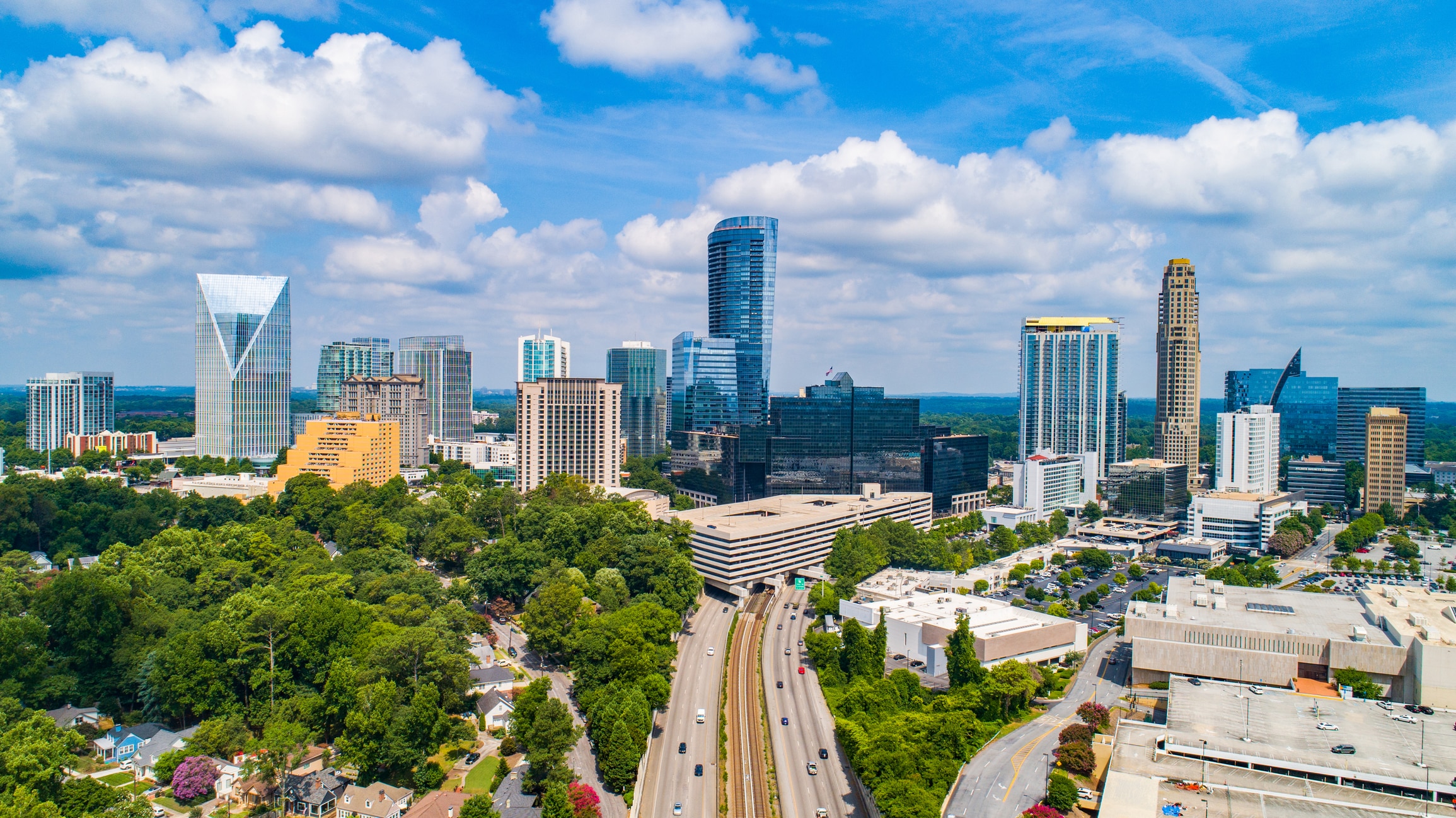 Buckhead Aerial near Downtown Atlanta Georgia The downtown Atlanta skyline in the day time with a bright, blue sky and white, fluffy clouds