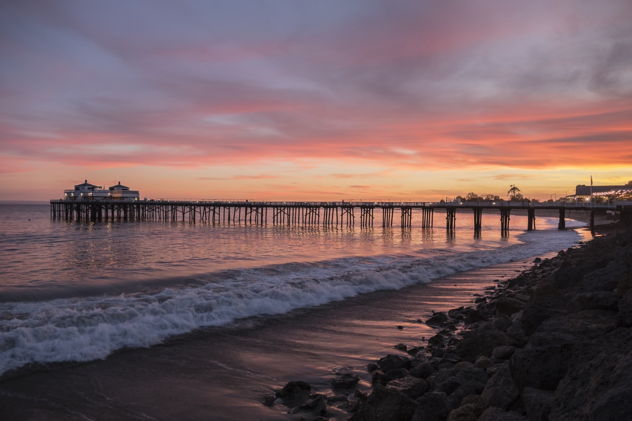 Malibu Pier California Sunset Malibu Pier at sunset, with the pier stretching into the ocean and waves crashing on the shore