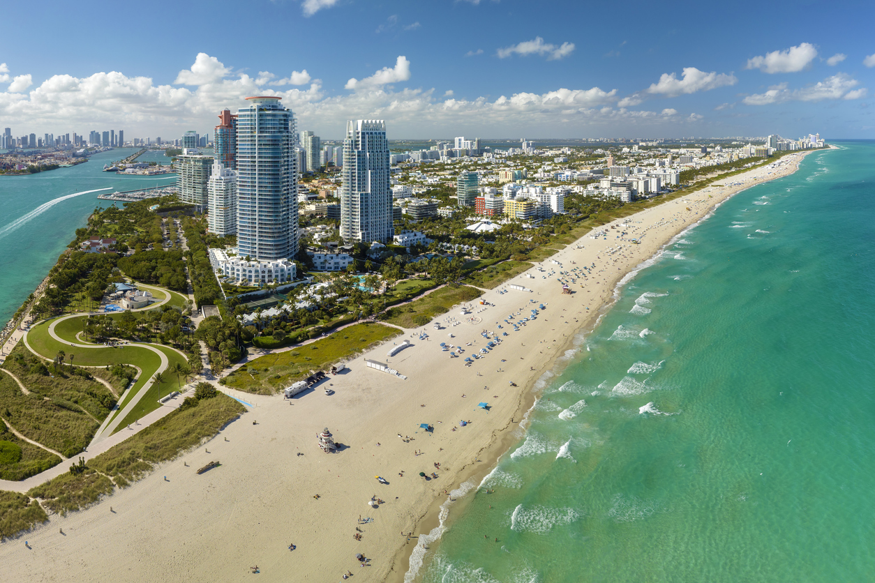 Aerial view of Miami Beach, specifically the South Beach area, characterized by its sandy beaches, turquoise waters, and Art Deco architecture
