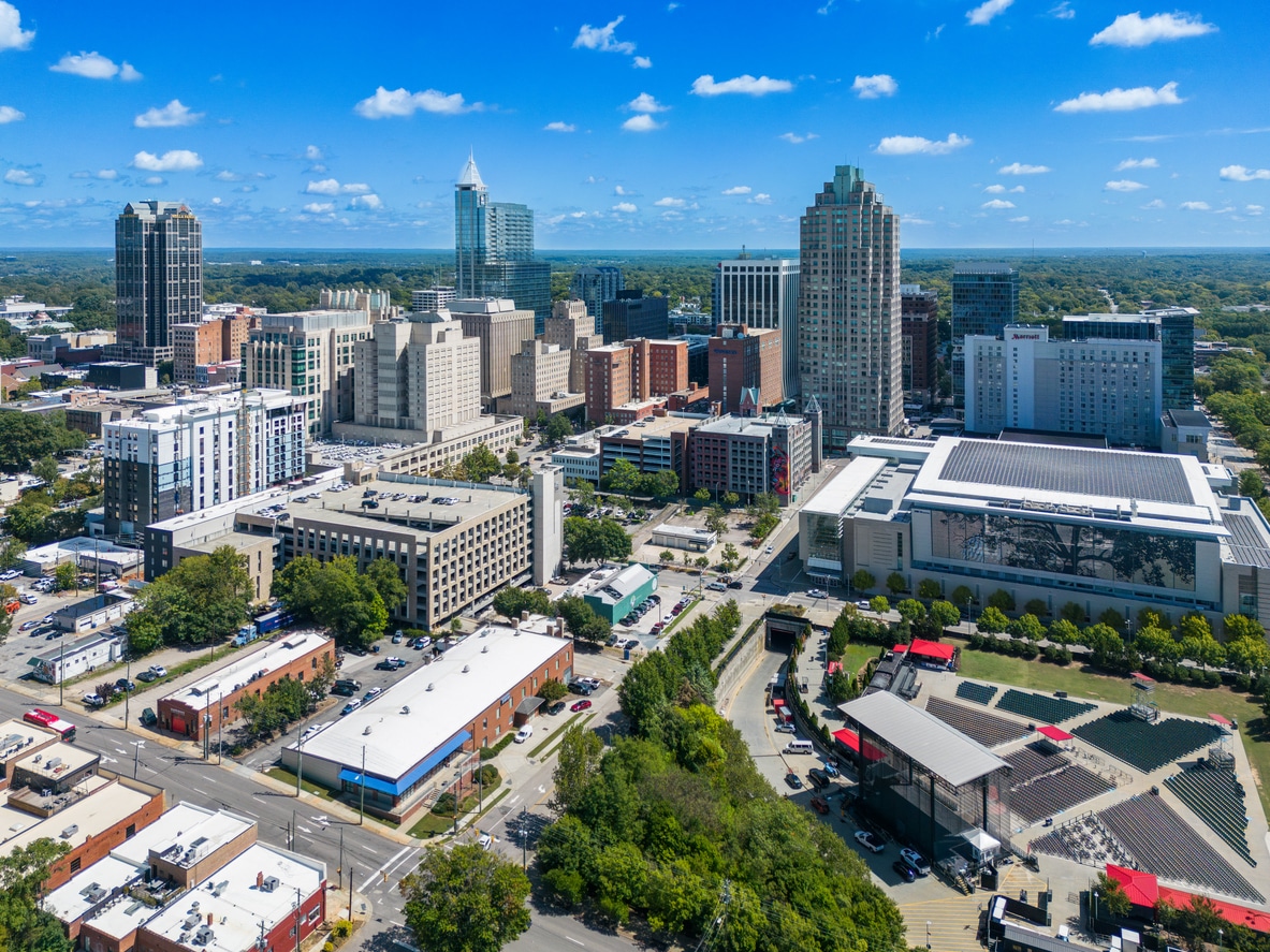 Raleigh, North Carolina Aerial view of downtown Raleigh, NC, showcasing skyscrapers, city blocks, and a modern outdoor amphitheater