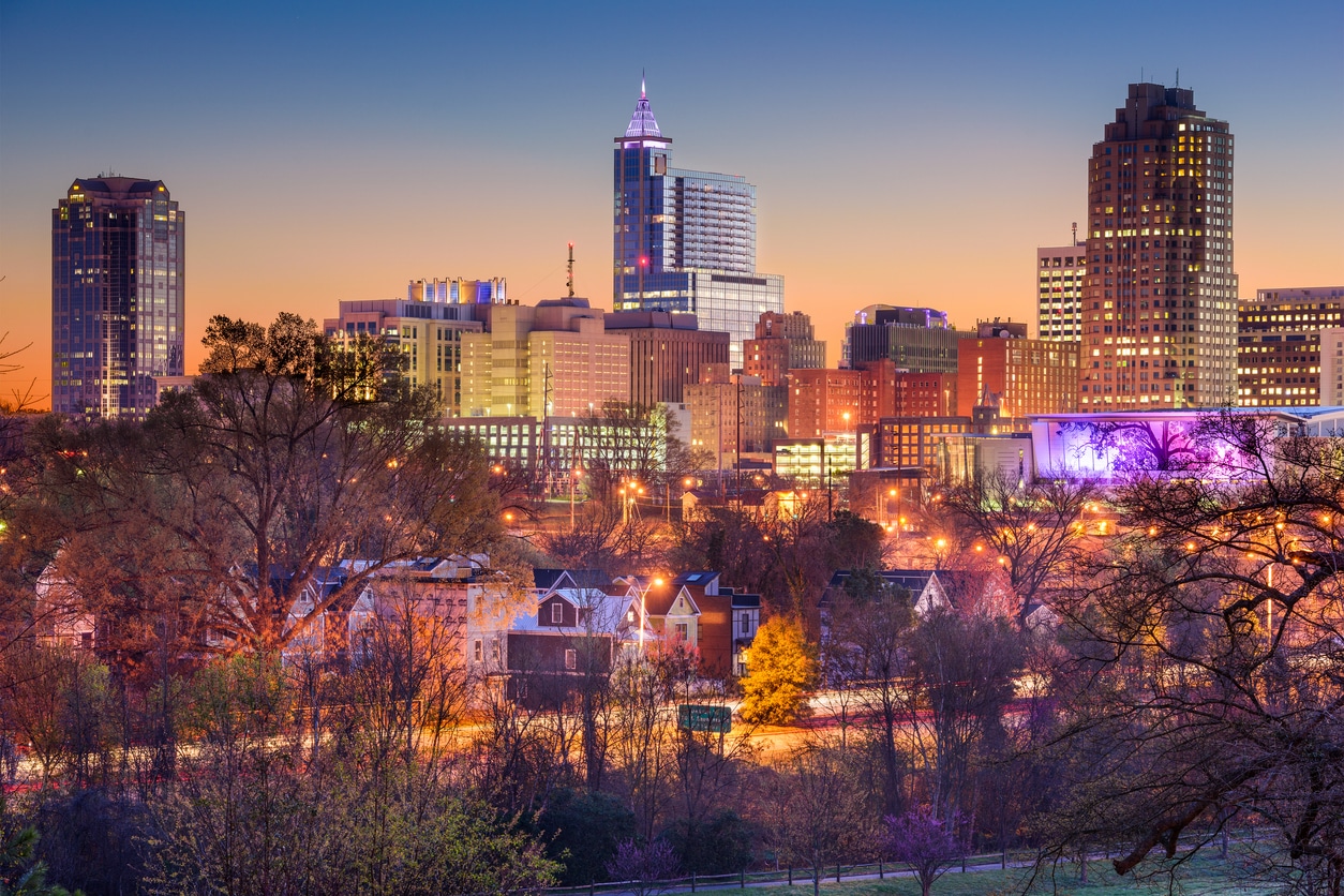 Raleigh Skyline Raleigh cityscape at dusk, capturing a mix of modern skyscrapers and older buildings