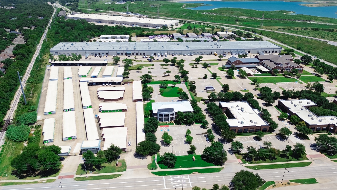 A large industrial complex with low-rise buildings, parking lots, and surrounding green areas in the Fort Worth area