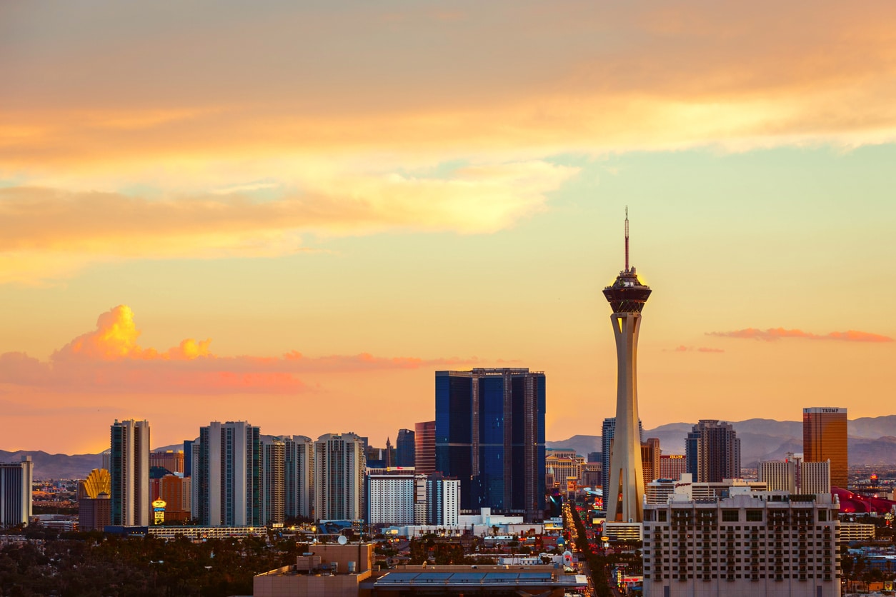 Las Vegas skyline at sunset, featuring the Stratosphere Tower and high-rises, an iconic glimpse into living in Nevada