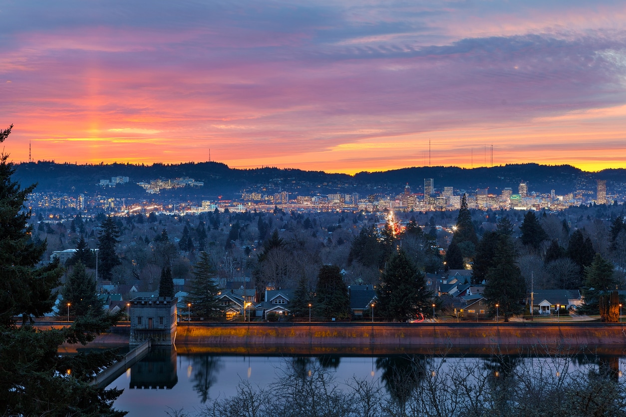 Sunset over Mt Tabor City Park Reservoir and the skyline of Portland OR USA Mount Tabor Park at sunset, with reservoir reflecting city lights and colorful sky, a highlight for those living in Portland