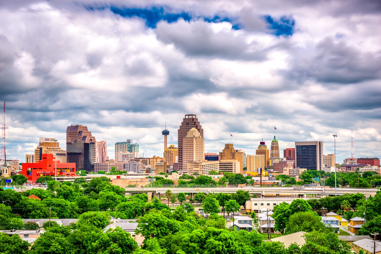 San Antonio, Texas, USA Skyline Cloudy sky over San Antonio with the Tower of the Americas and lush greenery in the foreground
