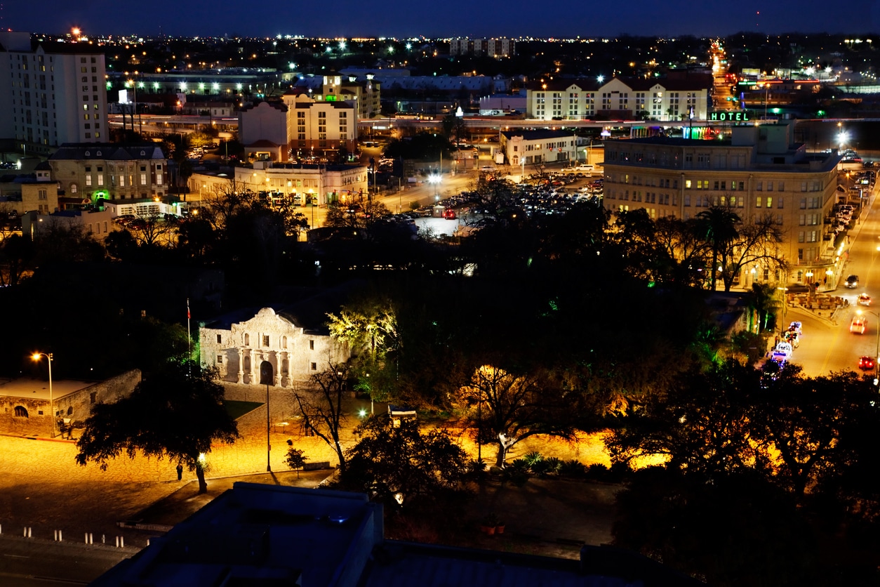 Alamo Plaza, San Antonio Aerial nighttime view of the Alamo in San Antonio, illuminated amid surrounding city lights and buildings