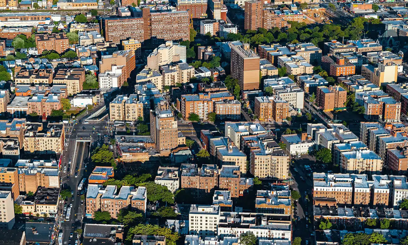 Aerial view of the Bronx neighborhoods, with dense residential and commercial buildings, streets, and green spaces
