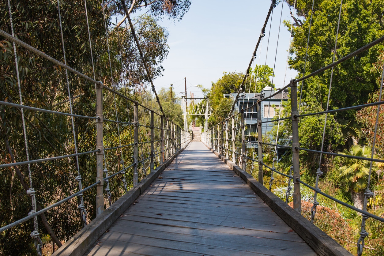 Spruce Street Suspension Bridge in a top San Diego neighborhood, surrounded by lush greenery