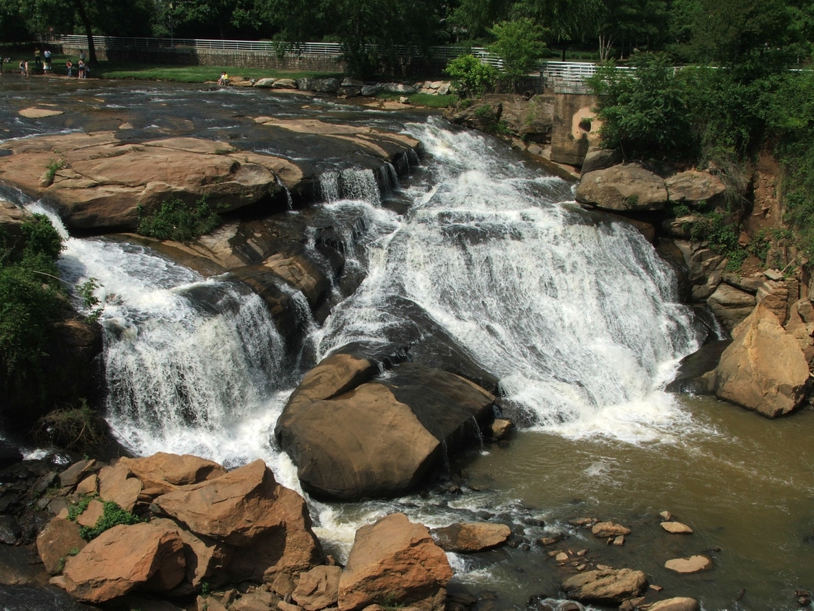 Scenic view of Reedy River Falls in Falls Park, a beautiful sight for those moving to Greenville, SC to look forward to