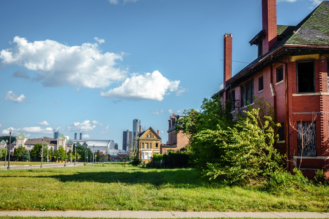Residential homes in a Detroit neighborhood with modern homes and the downtown skyline in the distance