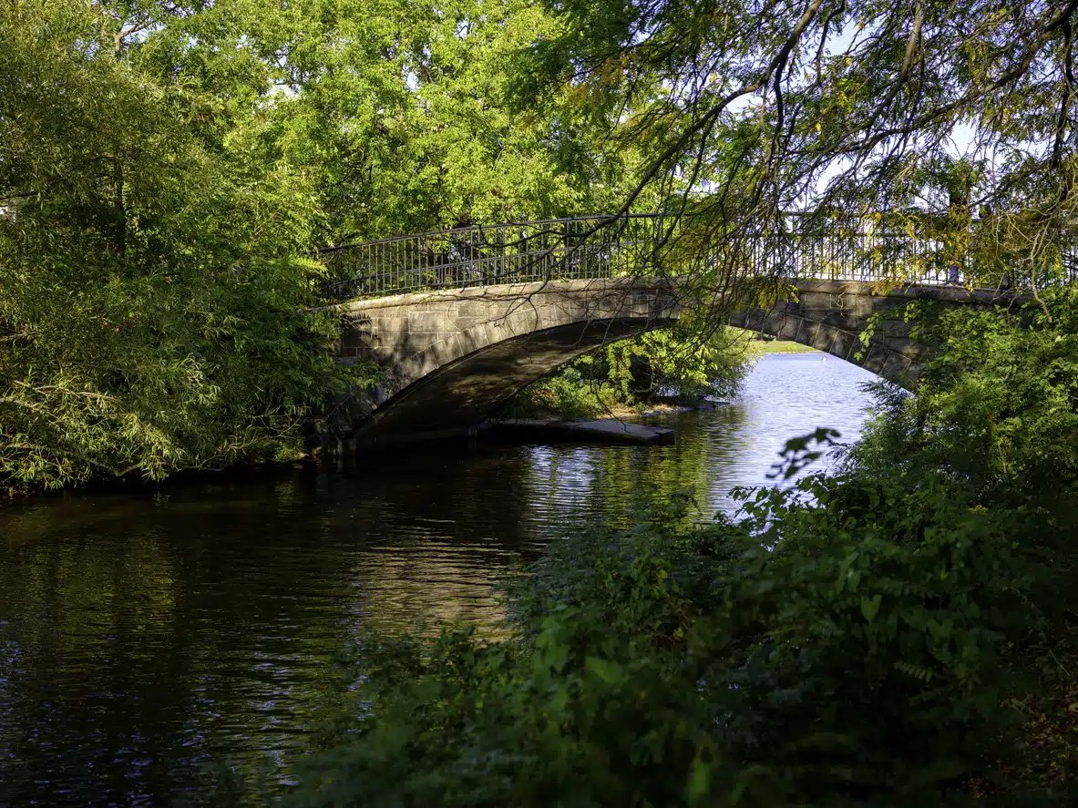 Arch bridge over a lagoon at Boston’s Charles River Esplanade in one of the best Boston neighborhoods
