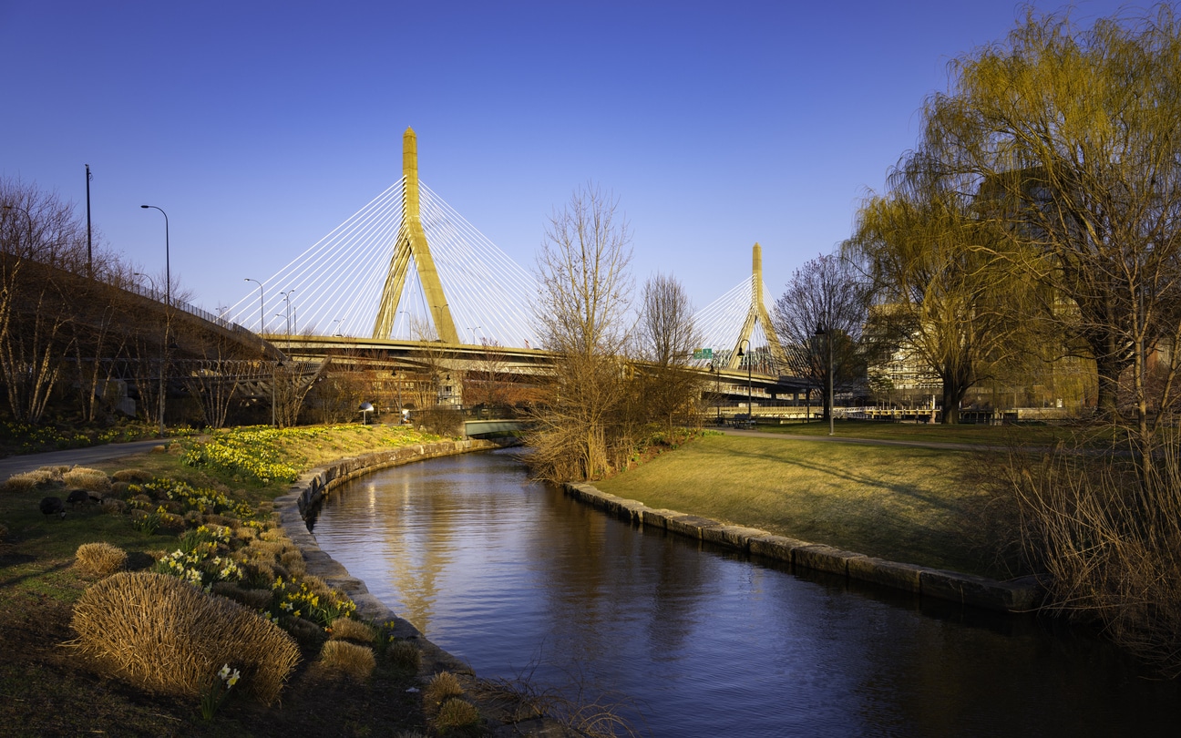 Zakim Bridge spans the Charles River in Boston, with North Point Park’s promenade and green space