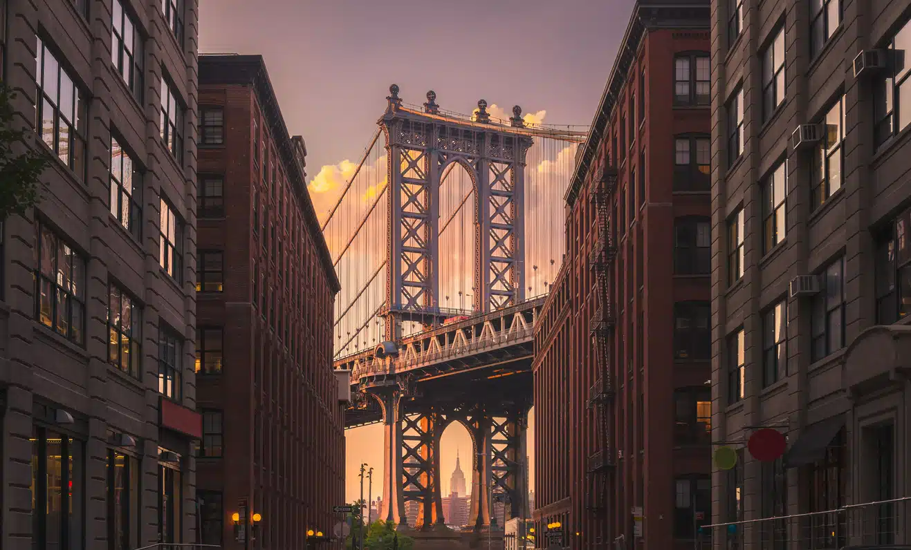 Manhattan Bridge framed by DUMBO's brick buildings in Brooklyn, a beautiful sight for those living in Brooklyn