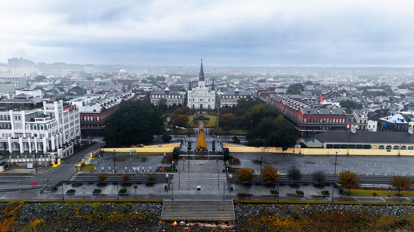 Aerial view of Jackson Square and St. Louis Cathedral in New Orleans, surrounded by historic buildings and greenery
