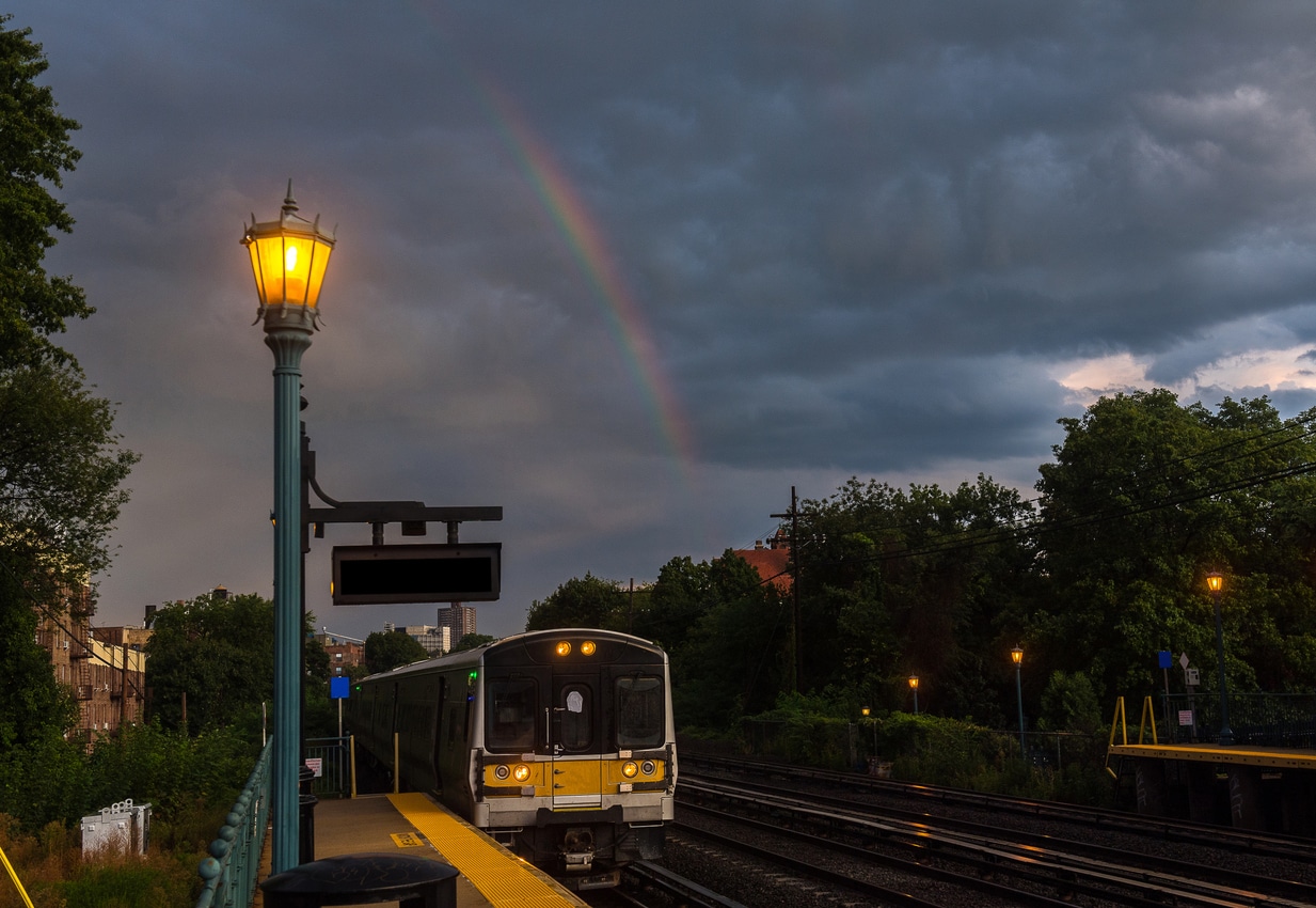 A station platform at dusk with an LIRR train, a common mode of transport for those living on Long Island